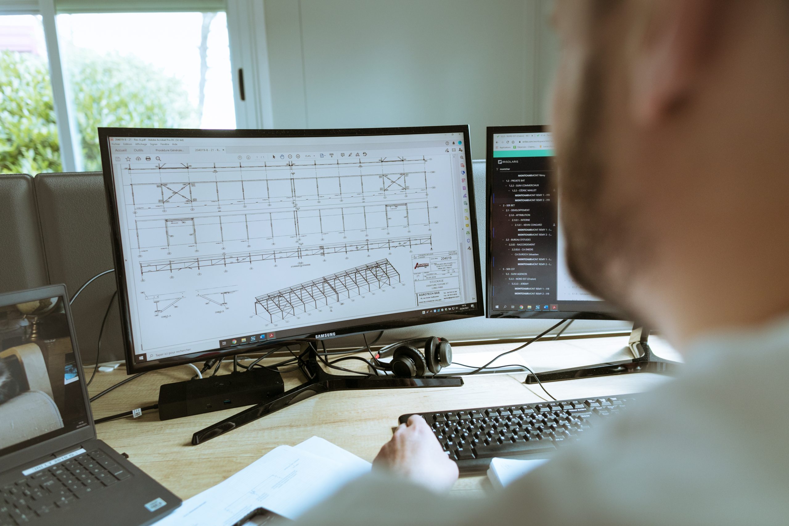 Homme regardant le plan d'un bâtiment sur un ordinateur